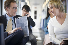 woman facing man holding newspaper